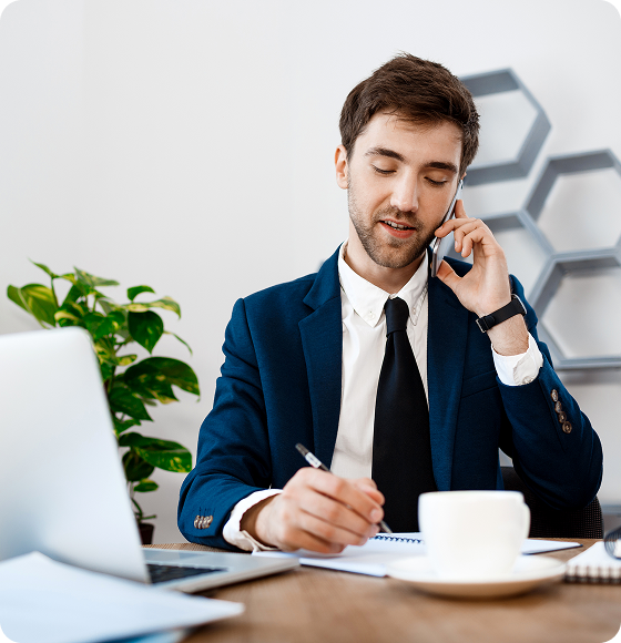 young-successful-businessman-speaking-phone-office-background